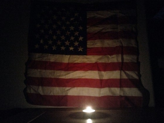 US flag candle light pray for America